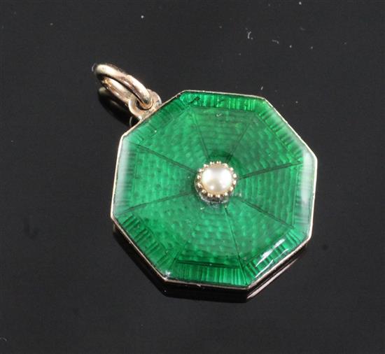 An Edwardian gold, green guilloche enamel and split pearl set octagonal pendant locket, 0.75in.